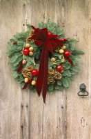 Traditional Christmas wreath on old oak door in Winter - December
