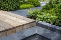 Salvaged scaffolding board decking with grey stone paving steps and path