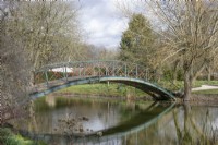 Metal bridge over the river running through Chippenham Park Gardens, March
