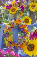 Floral display of bouquets and a wreath featuring Helianthus, Cosmos, Calendula, Tropaeolum, Dahlia and wildflowers.