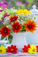 Flower bouquet in milk jug with Heliopsis helianthoides, Clematis seedheads and Sunflower.