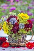 Flower bouquet with Fennel, Echinops, Dahlia and Helianthus in a home made bark and moss tea cup.