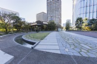 Main  plaza with view to surrounding skyscrapers. Circular terrace of paved and concrete surfaces with surrounding rill. 