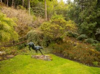 A bronze cheetah sculpture by Hamish Mackie and a bed of Euphorbia next to the steps to the viewing area.