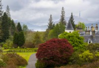 The turret and chimneys of Attadale House, Acer griseum and a view  to Lochcarron from the viewing point.