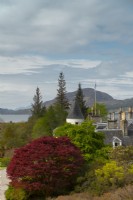 The turret and chimneys of Attadale House, Acer griseum and a view to Lochcarron from the viewing point.