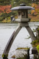 The Kotoji two-legged stone lantern at the edge of the Kasumigaike Pond. 