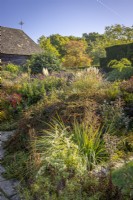 The Barn Garden in autumn with Cotoneaster horizontalis in the foreground