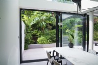 View from contemporary dining area to garden through patio doors