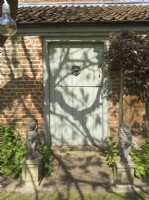 Cottage door with stone lion sculptures