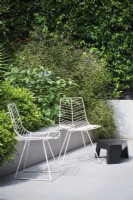 Modern white metal garden chairs and low black table