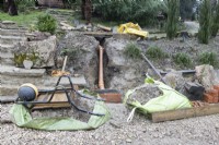 Renovation work on an old drainage system and drain, with various pieces of building equipment and dumpy bags of earth around the work.  