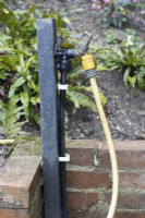 A standing tap with hose attched. 