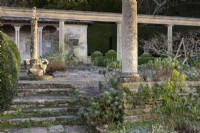 Roman column and Byzantine wellhead on the Great Terrace at Iford Manor in January