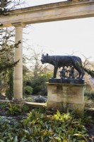 Statue of Romulus and Remus suckled by the she-wolf below the colonnade at Iford Manor in January