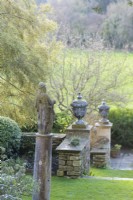 Sculptures and urns punctuating terraces at Iford Manor in January