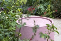 Pastel pink circular water feature. The RHS and Eastern Eye Garden of Unity. Designer: Manoj Malde