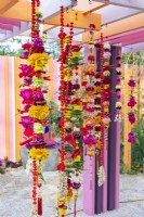 Marigold Garlands made with flowers, chilli peppers and fruits. The RHS and Eastern Eye Garden of Unity, Designer: Manoj Malde.