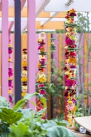 Marigold Garlands made with flowers, chilli peppers, fruits, pom-poms and bracelets