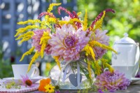 Pink Dahlias, Solidago and Amaranthus in a glass vase.