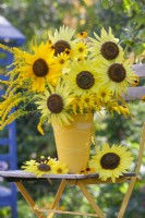 Yellow themed floral arrangement with Helianthus and Solidago.