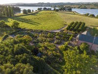 Aerial view of the dry garden with Blagdon Lake at Holt Farm Organic Garden