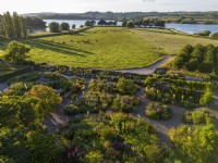 Aerial view of the dry garden with Blagdon Lake at Holt Farm Organic Garden