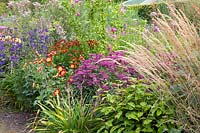 Bed with perennials, dahlias and reed grass 