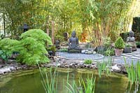 Seating area with Buddha statue, Phyllostachys vivax, Acer palmatum Dissectum 