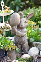 Easter decoration with wooden bunny and Primula victoriana 
