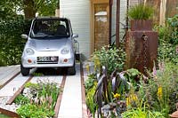 Front garden with parking space for electric car 
