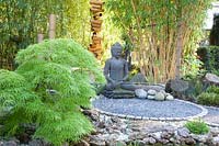 Seating area with Buddha statue, Phyllostachys vivax, Acer palmatum Dissectum 