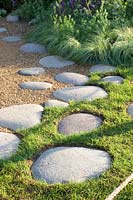 Path with stepping stones and sedge, Carex comans Amazon Mist 