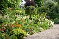 Front garden with Hydrangea arborescens Annabelle, Berberis, Helenium, Crocosmia 