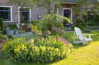 Seating area rural garden, Alchemilla mollis, Salvia nemorosa East Frisia 