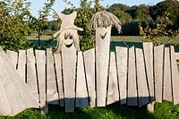 Original wooden fence with figures 
