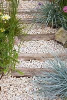 Gravel path with wooden planks 
