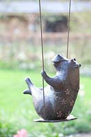 Bronze sculpture hippo on a swing 