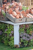Clay pots on a vertically planted table 