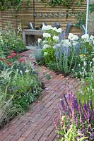 Small garden with brick path 