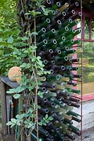 Trellis with old bottles 