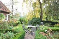 Country garden with seating area in October 