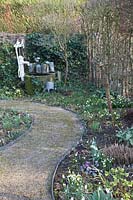 Winter garden with snowdrops and fountain, Galanthus 