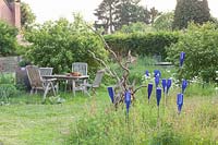 Country garden with seating area in a meadow 