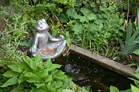 Small Buddha frog at a water basin 