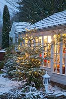 Illuminated garden house in winter 