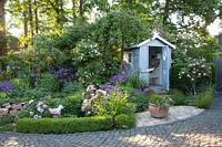 Garden with beach hut, Rosa Eden Rose, Rosa Mortimer Sackler, Rosa Blush Noisette 