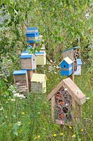 Birdhouses and insect hotel in the natural garden 