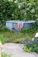 Cottage garden with old bathtub for dyeing wool 
