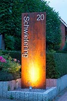 Illuminated stele with house number 